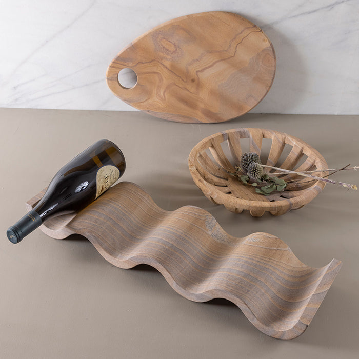 Natural rainbow sandstone wine rack with a modern wave design, holding a wine bottle.