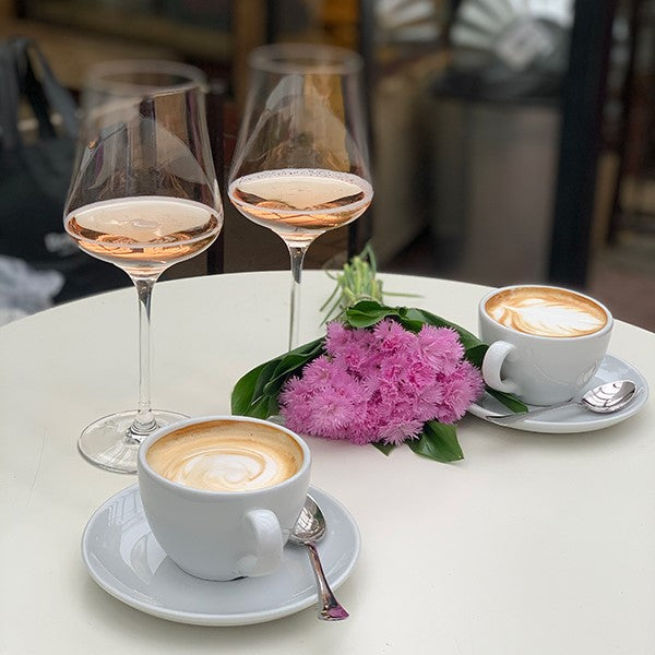 coffee and wine on table with oink flower