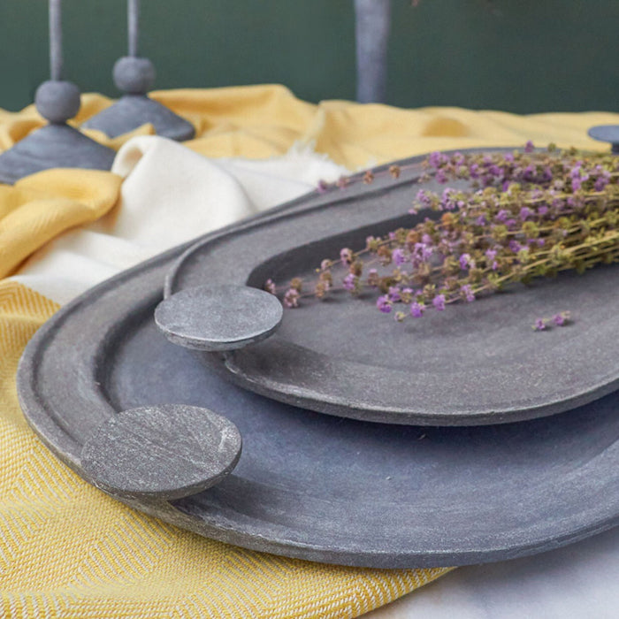 Handcrafted Petra Zinc Trays in small and large sizes, featuring a textured finish, displayed with dried lavender on a soft fabric background.